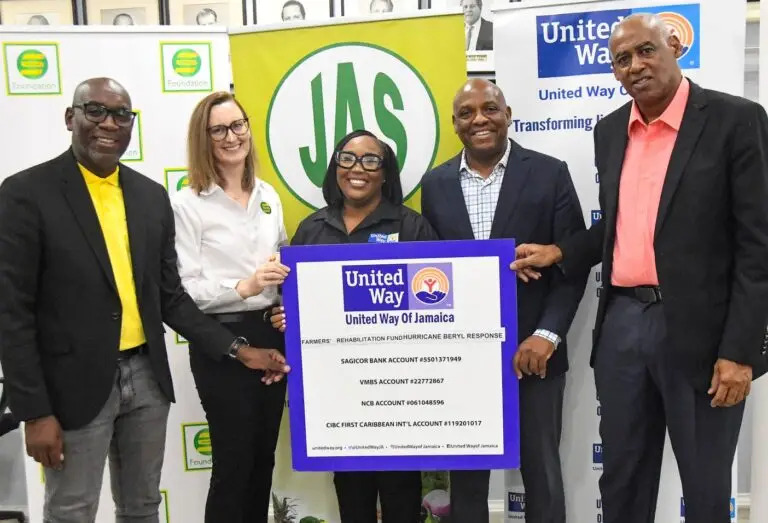CEO of UWJ Taneshia Stoney (left) is joined by Charmaine Brimm, technical specialist at PIOJ and the Custos Rotulorum Ian Forbes, as she presents the symbolic grant cheque to representatives of the Phoenix Girls Foundation.